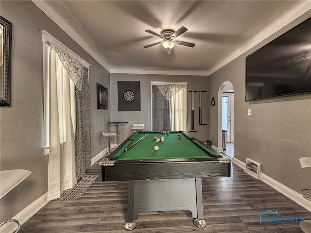 playroom featuring visible vents, arched walkways, dark wood finished floors, and a textured wall