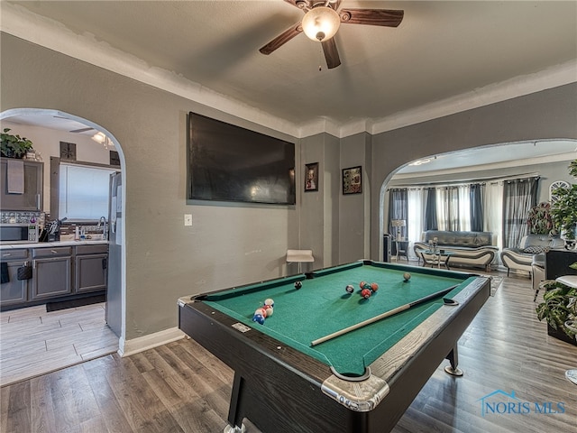 game room with a ceiling fan, billiards, arched walkways, light wood finished floors, and baseboards