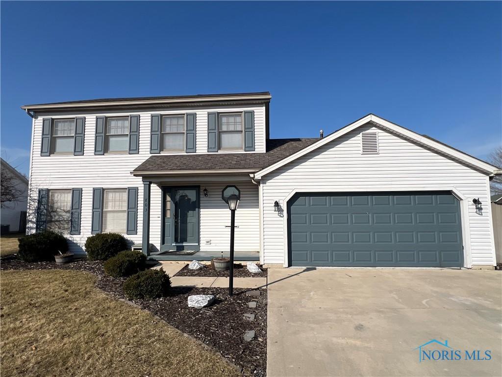 view of front of home featuring roof with shingles, concrete driveway, and an attached garage