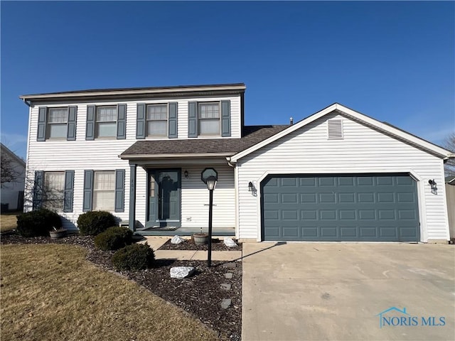 view of front of home featuring roof with shingles, concrete driveway, and an attached garage