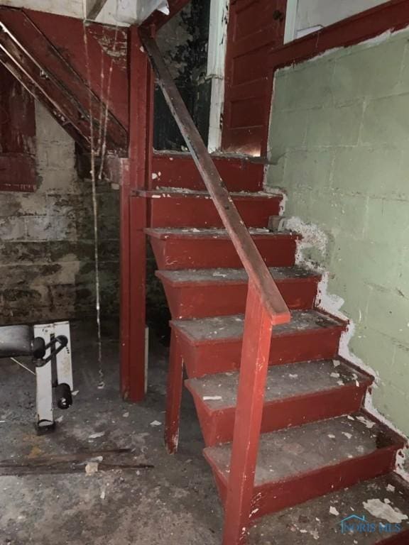 staircase with concrete block wall