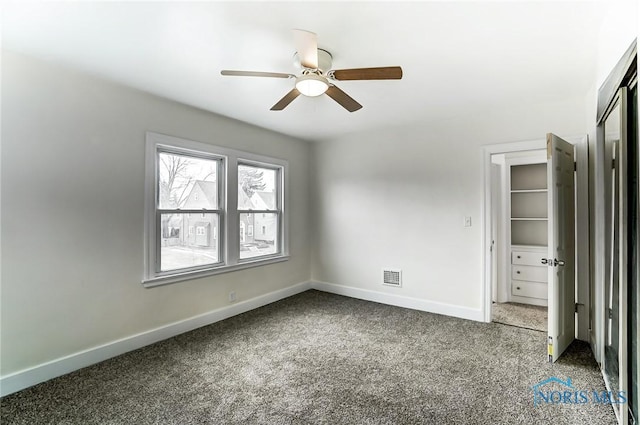 unfurnished bedroom with carpet, visible vents, a closet, and baseboards