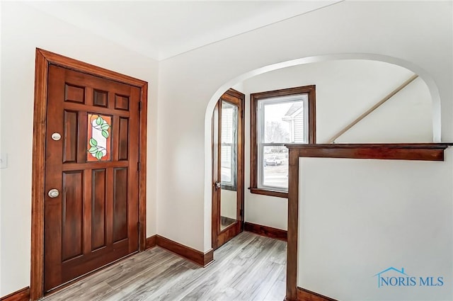 entrance foyer with baseboards and light wood finished floors