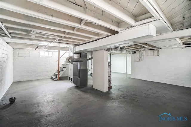 1488 Gould Rd, Toledo, OH 43612 - unfinished below grade area featuring concrete block wall, heating unit, and stairway
