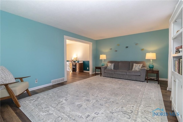 living room with visible vents, dark wood-style floors, and baseboards