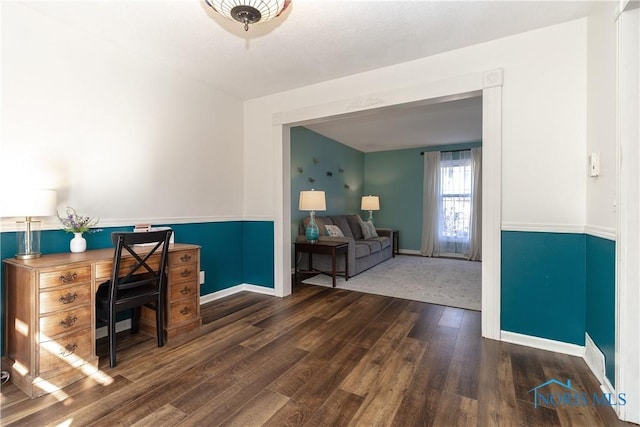 office space with wood finished floors and baseboards