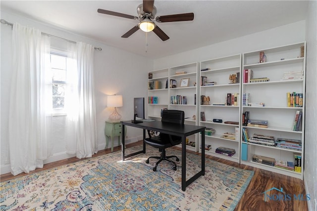 office with baseboards, a ceiling fan, and wood finished floors