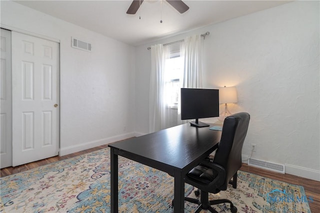 home office featuring visible vents, baseboards, and wood finished floors