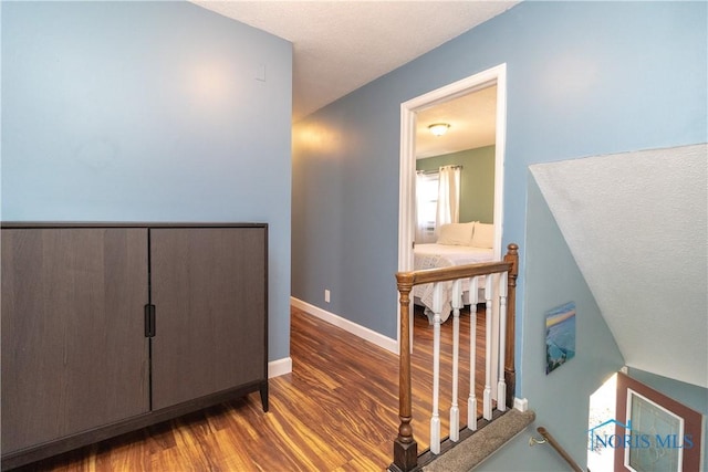 interior space with baseboards and wood finished floors