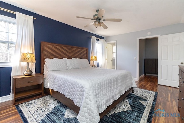 bedroom featuring ceiling fan, baseboards, and wood finished floors