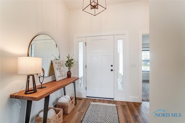 5224 Rail St, Monclova, OH 43542 - foyer featuring a notable chandelier, wood finished floors, baseboards, and a towering ceiling