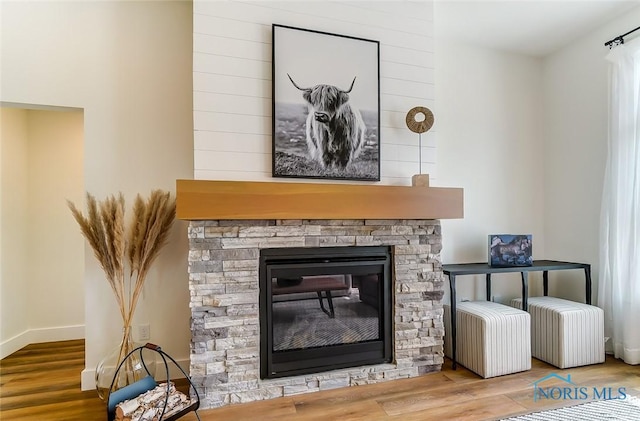 5224 Rail St, Monclova, OH 43542 - room details with a stone fireplace, wood finished floors, and baseboards