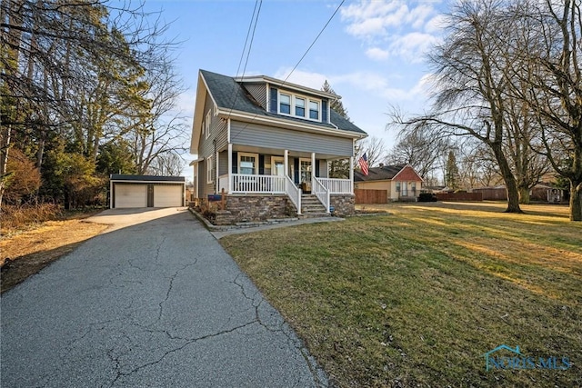 bungalow-style house featuring a detached garage, an outbuilding, covered porch, and a front yard