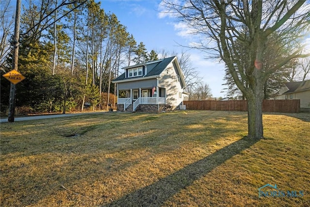 exterior space featuring a porch, fence, and central AC