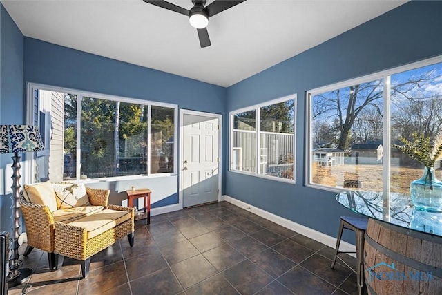 sunroom featuring a ceiling fan and a healthy amount of sunlight