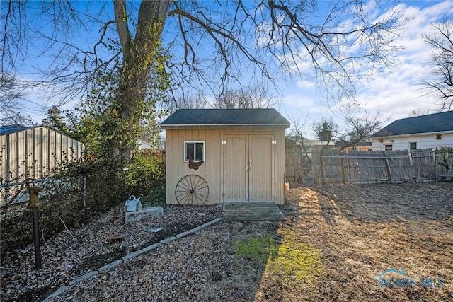 view of shed featuring fence