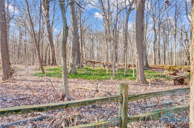 view of yard with a view of trees