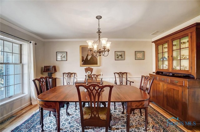 dining area featuring light wood-type flooring, visible vents, plenty of natural light, and an inviting chandelier