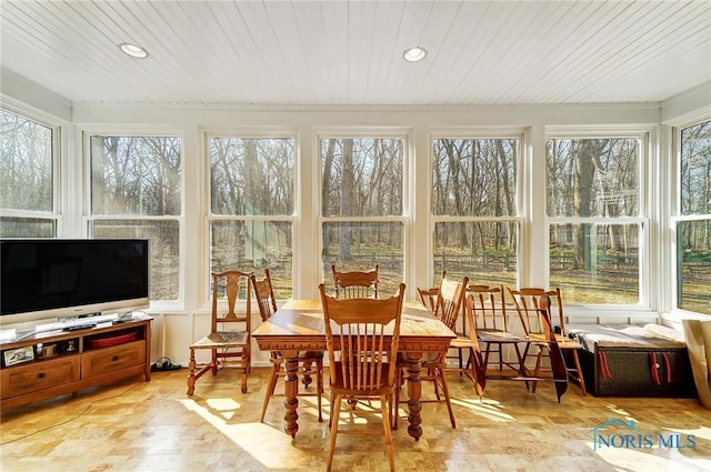 sunroom with a wealth of natural light and wood ceiling