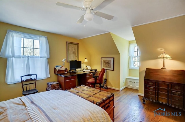 bedroom featuring wood finished floors, baseboards, and ceiling fan