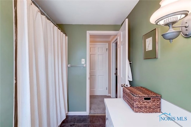 full bathroom featuring tile patterned flooring and baseboards