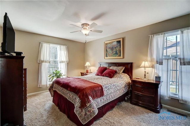 bedroom featuring visible vents, carpet flooring, baseboards, and ceiling fan