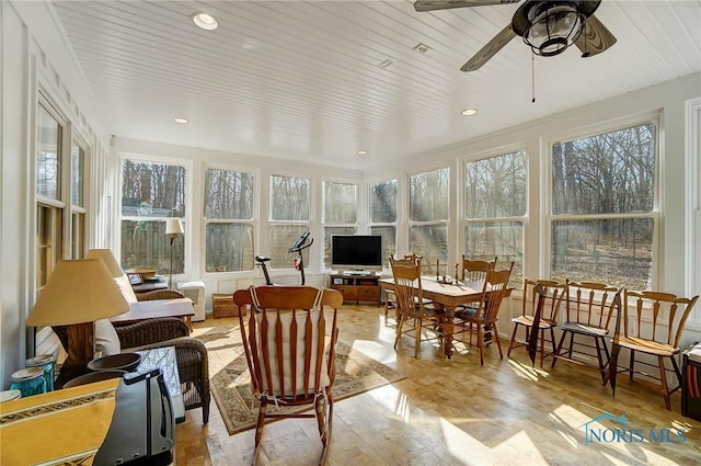 sunroom / solarium featuring wood ceiling and a ceiling fan