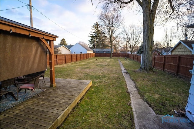 view of yard with a fenced backyard and a wooden deck