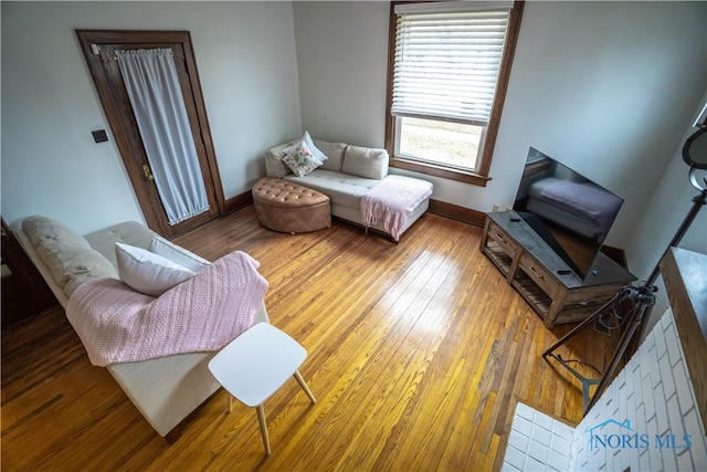 living room featuring hardwood / wood-style flooring and baseboards