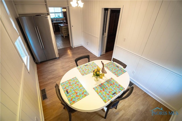 dining room featuring dark wood-type flooring and visible vents