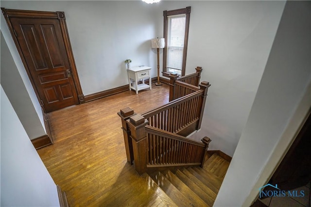 stairs featuring baseboards and wood finished floors