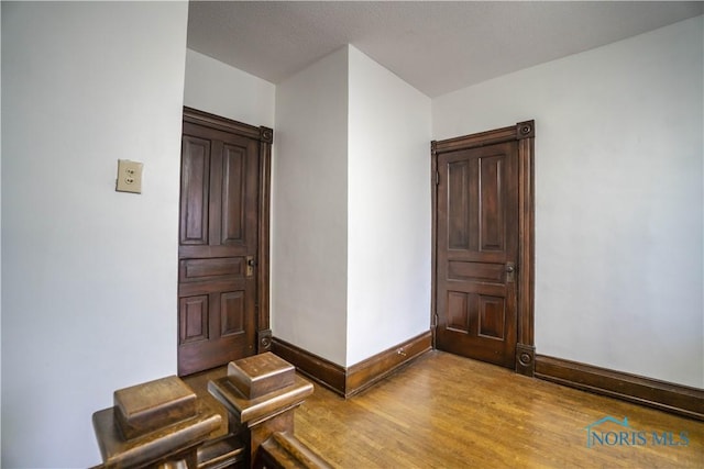 interior space with baseboards and light wood-style flooring