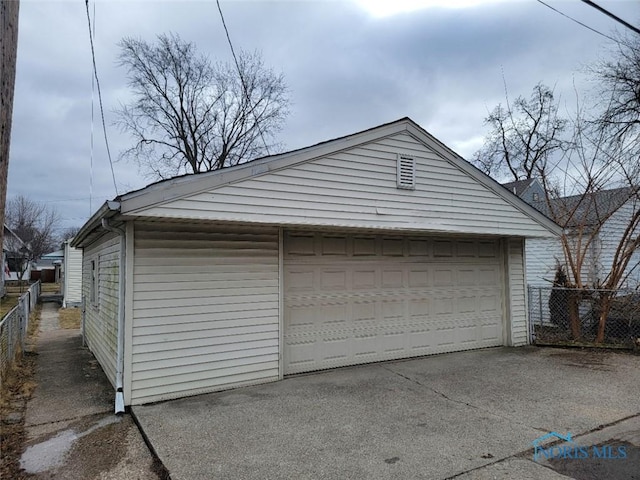 detached garage featuring fence