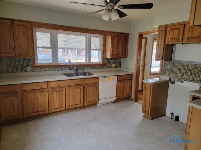 kitchen featuring brown cabinets, dishwasher, ceiling fan, and a sink