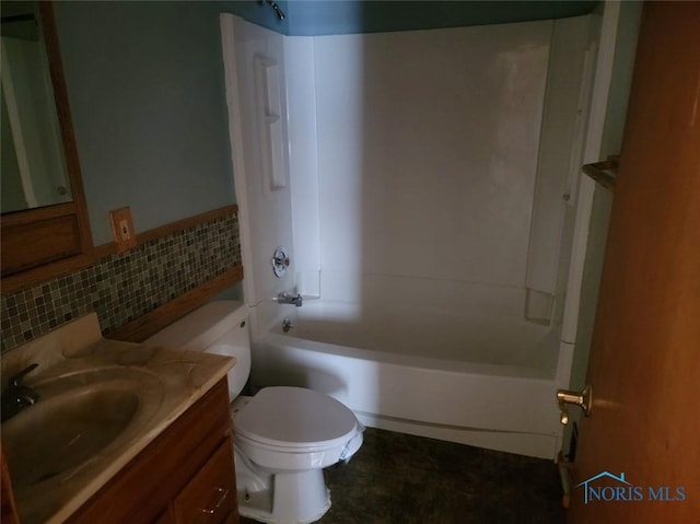 full bath with toilet, vanity, tile walls, and shower / bath combination