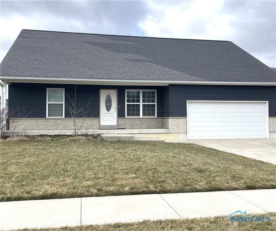 single story home featuring driveway, a shingled roof, a front lawn, stone siding, and a garage