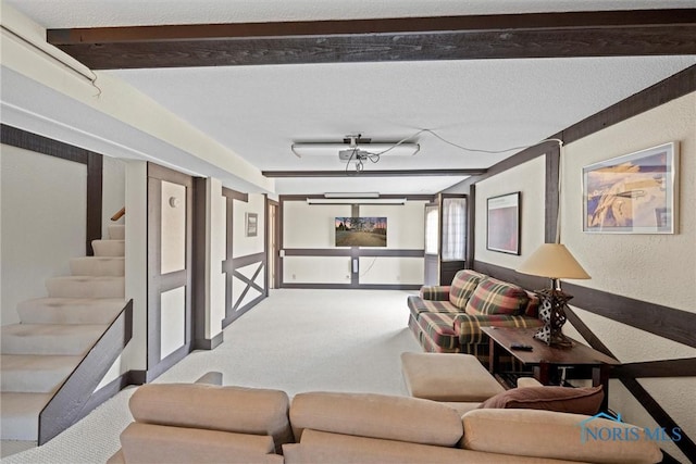 carpeted living room with stairway, a textured wall, baseboards, and a textured ceiling