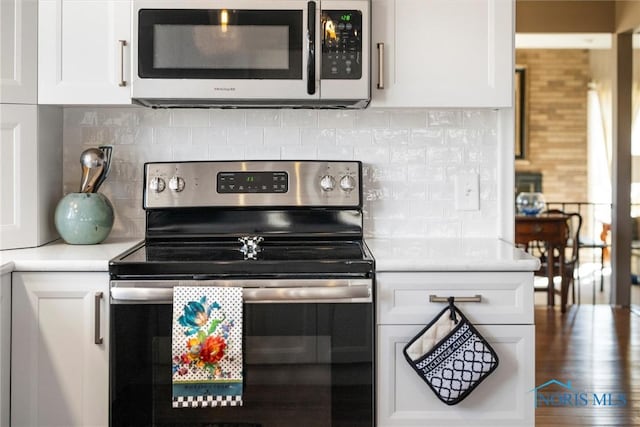 kitchen featuring white cabinetry, light countertops, backsplash, and stainless steel appliances