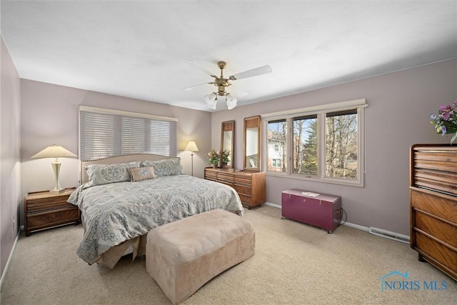 carpeted bedroom featuring visible vents, a ceiling fan, and baseboards