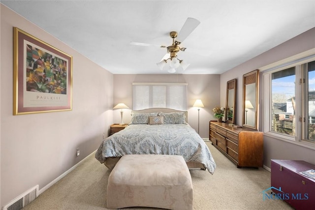 bedroom featuring visible vents, carpet flooring, a ceiling fan, and baseboards