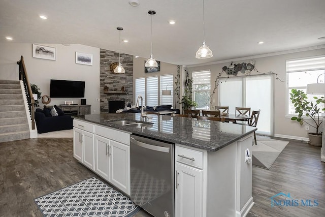 kitchen featuring a sink, a wealth of natural light, stainless steel dishwasher, and open floor plan