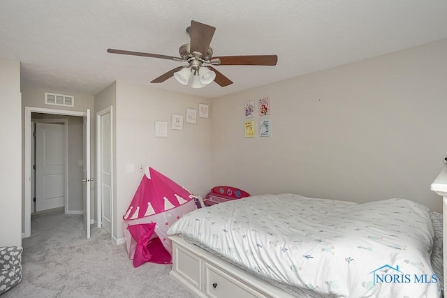 bedroom with visible vents, light colored carpet, a ceiling fan, and baseboards