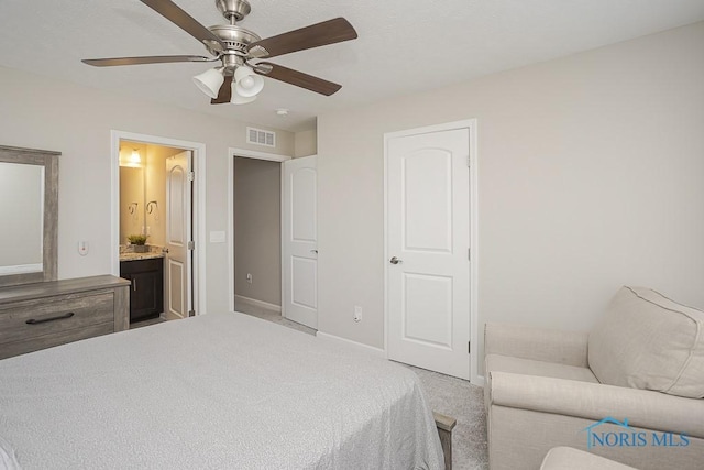 bedroom featuring baseboards, visible vents, ceiling fan, light carpet, and connected bathroom