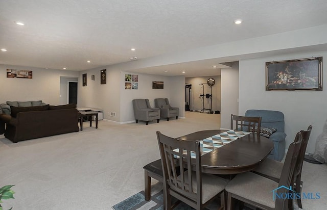 dining room with light carpet, recessed lighting, a textured ceiling, and baseboards