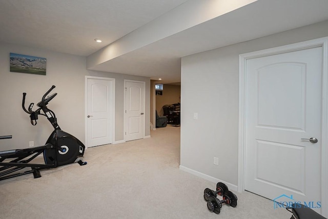 exercise room with recessed lighting, carpet, and baseboards