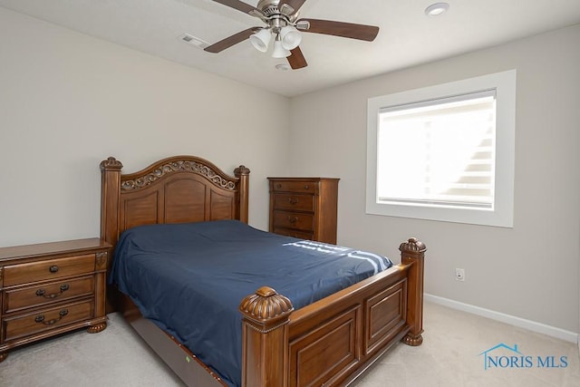 bedroom featuring baseboards, light carpet, visible vents, and a ceiling fan