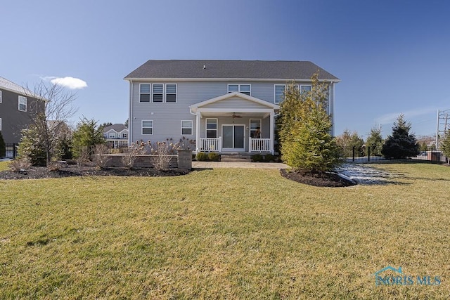 back of property with covered porch, a lawn, and a ceiling fan