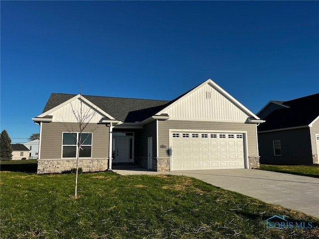 view of front of home featuring concrete driveway, a front lawn, a garage, stone siding, and board and batten siding