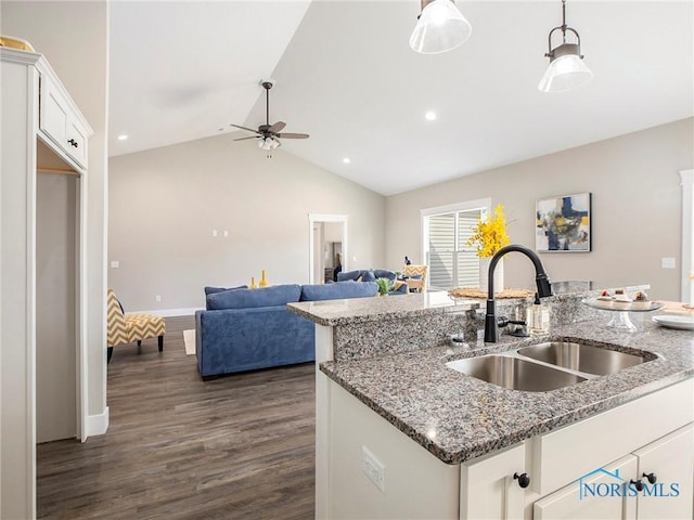 kitchen with dark wood-style flooring, ceiling fan, hanging light fixtures, a sink, and white cabinets