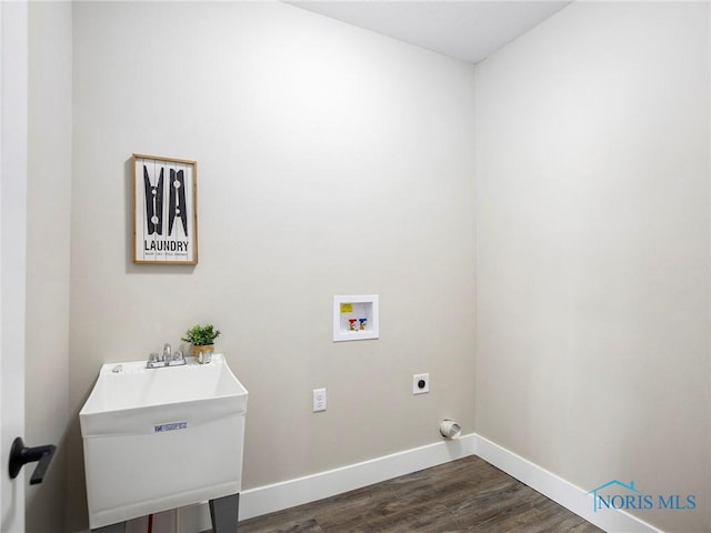 laundry area with laundry area, dark wood-style flooring, a sink, washer hookup, and electric dryer hookup